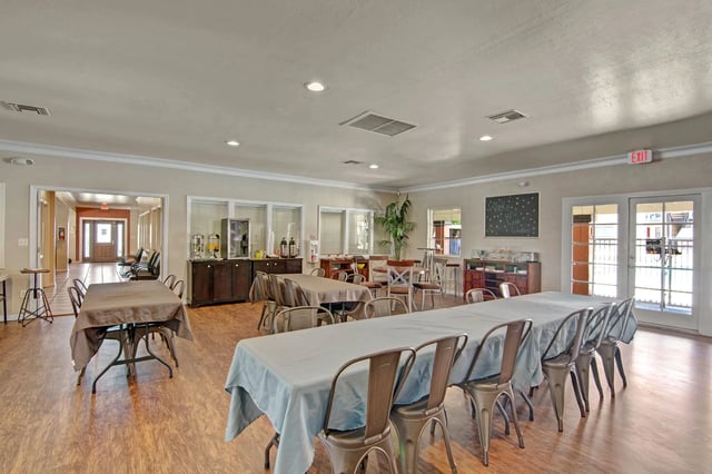 Community room with tables and chairs set up for an event.