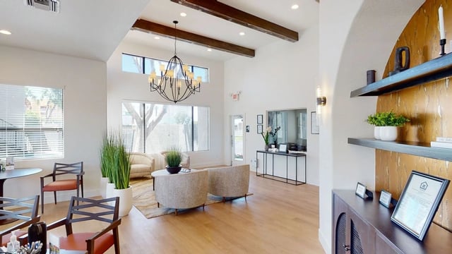 Interior view of a modern apartment building lobby with comfortable seating and decorative elements.