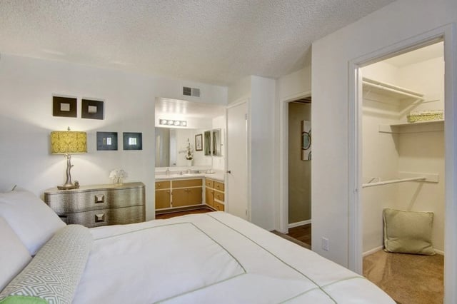 Bedroom with a vanity and closet.