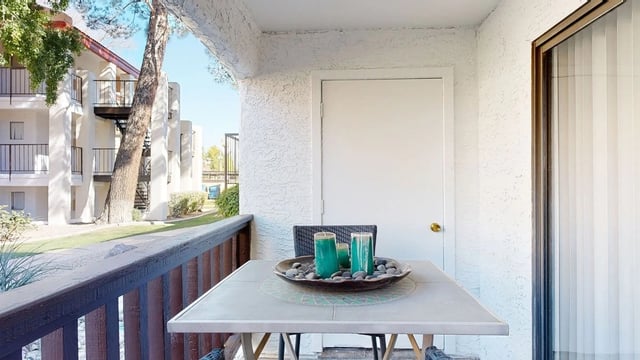 Balcony with table and chairs overlooking the property grounds