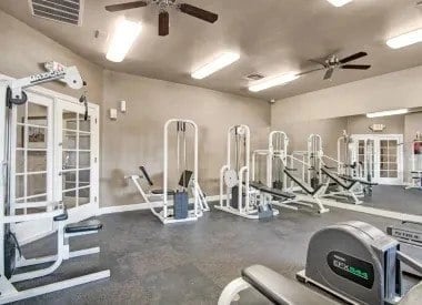 Fitness center with weight machines and exercise equipment.