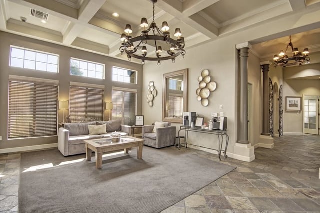 Lobby seating area with couches, coffee table, and coffee station.