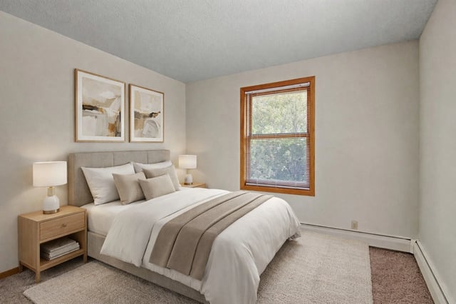 Bedroom with a queen-size bed, two nightstands with lamps, and two pieces of wall art above the headboard.