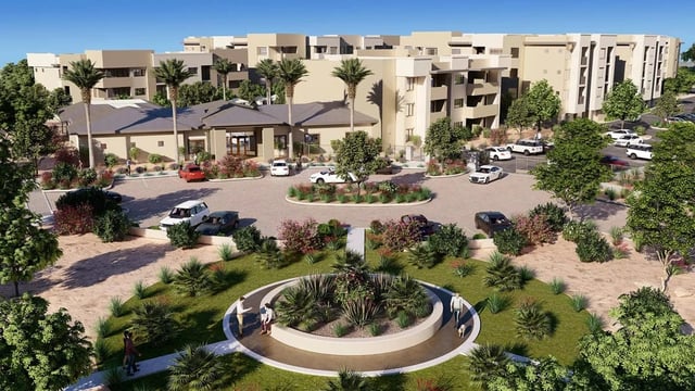 Exterior view of apartment buildings with a circular driveway and landscaping.