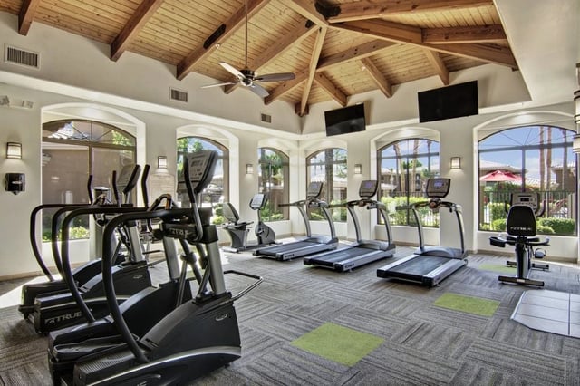 Fitness center with treadmills, elliptical machines, and a recumbent bike.