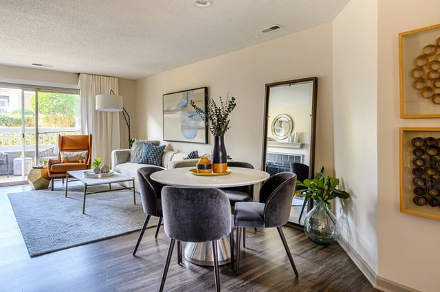 Modern dining area and living room with stylish furniture and decor.