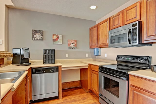 Kitchen with coffee maker, dishwasher, microwave, and stove.