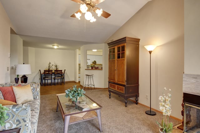 Living room with a sofa, coffee table, and dining area.