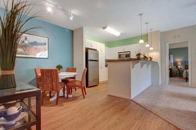 Kitchen and dining area in an apartment with a breakfast bar.