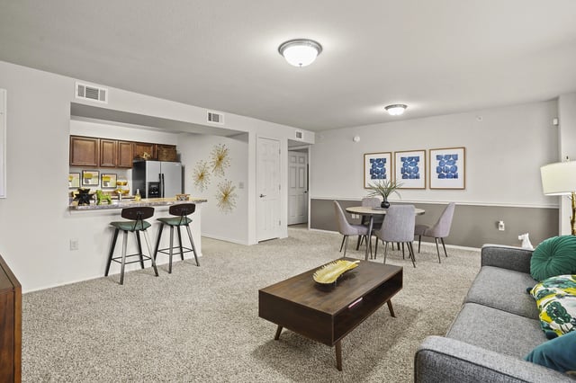 A living room with a grey couch and a coffee table.