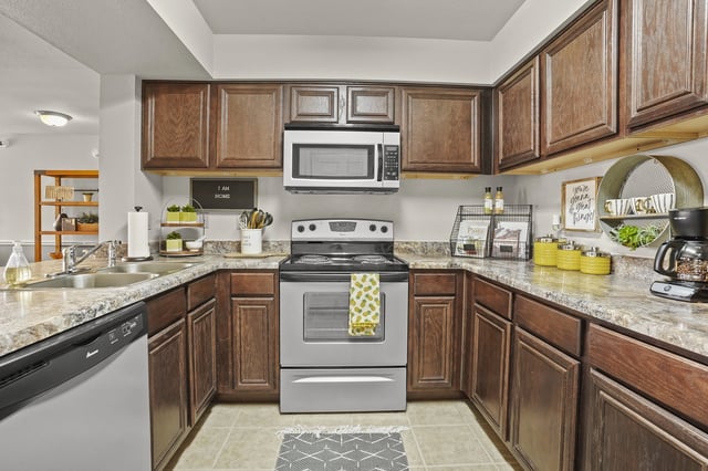 A kitchen with a stove top oven and a microwave above it.