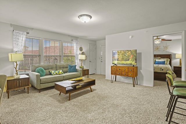 A living room with a couch, a chair, and a coffee table.
