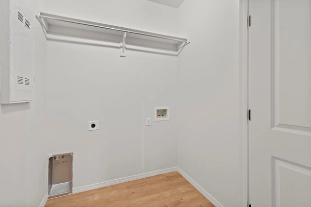 Laundry room with hookups for washer and dryer, and a closet rod.