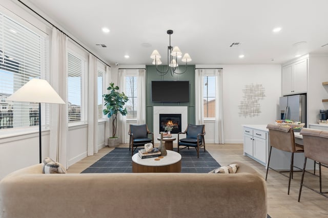 Living room with fireplace, TV, seating, and kitchen island.