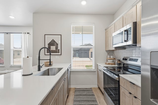 Modern kitchen with stainless steel appliances and ample counter space.