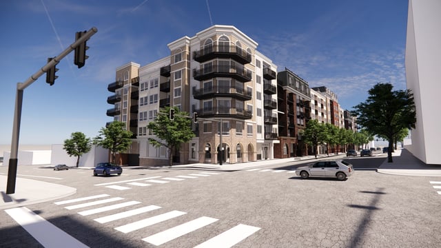 Exterior view of a multifamily property at a street intersection with cars driving by.