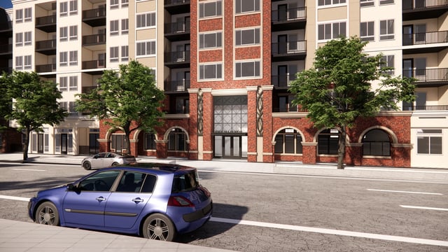 Exterior view of The Majestic apartment building with cars on the street.