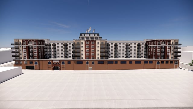 Exterior of a large apartment building with balconies under a clear blue sky.