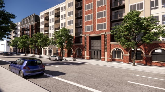 Exterior view of a modern apartment building facade with brick and white siding, balconies, and street-level retail.