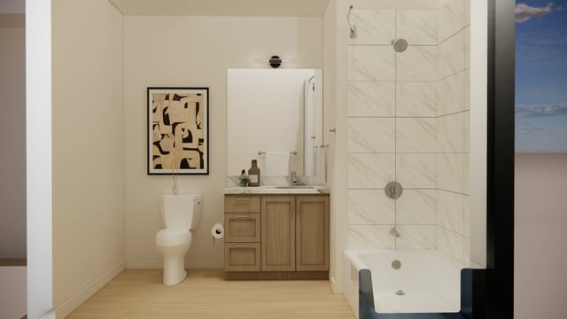 Modern bathroom with a white toilet, vanity, and bathtub.