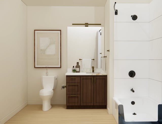 Modern bathroom with a toilet, vanity, and shower.