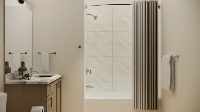 Modern bathroom with a vanity, sink, and bathtub with shower.