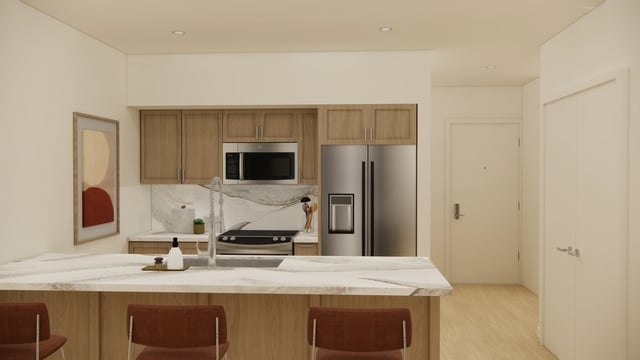 Modern kitchen with stainless steel appliances, marble countertops, and wooden cabinets.