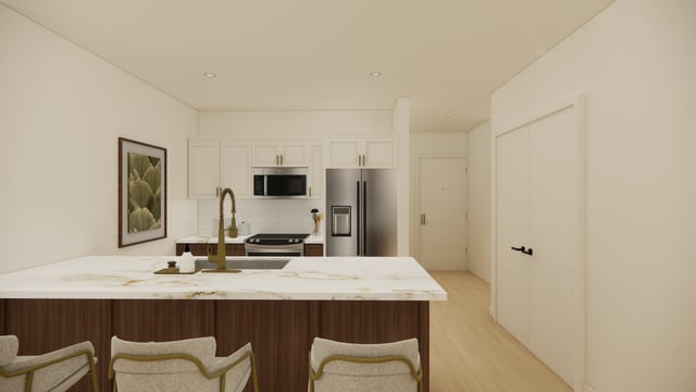 Modern kitchen with stainless steel appliances, white cabinets, and a large island.
