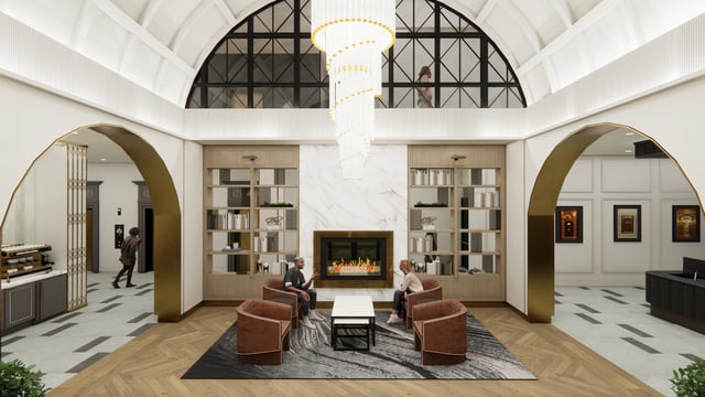 Modern lobby with fireplace, bookshelves, and seating area.