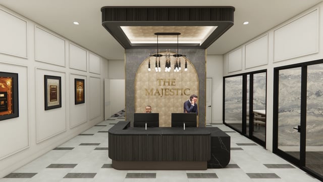 The Majestic apartment building lobby with a reception desk and two staff members.
