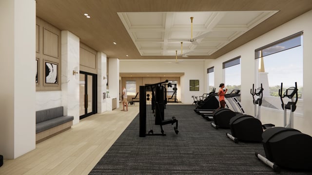 Fitness center with treadmills, elliptical machines, and weight equipment.