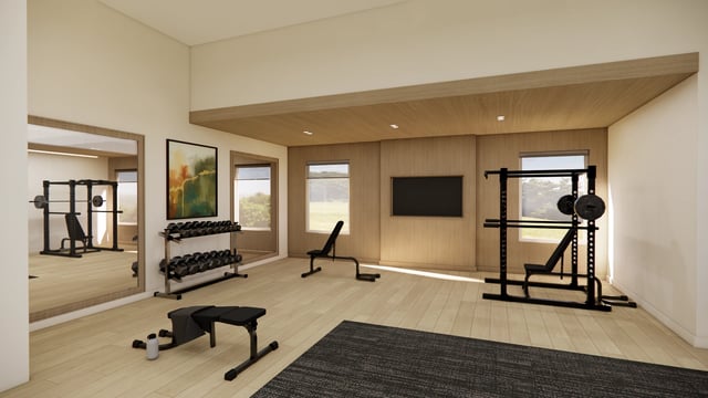 Fitness center with weight racks, dumbbells, and benches.