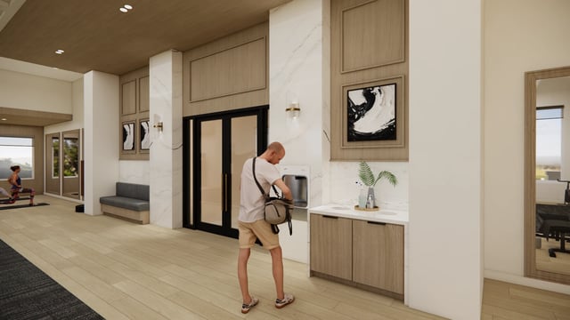 Interior view of a modern apartment building lobby with a yoga area and water fountain.