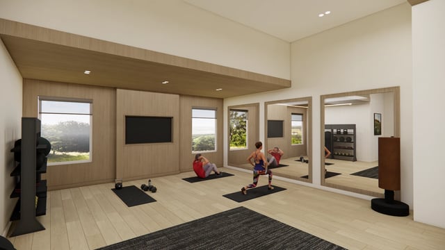 People exercising in a modern fitness studio with mirrors and workout equipment.