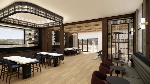 Modern kitchen and lounge area with bar seating, communal tables, and a fireplace.