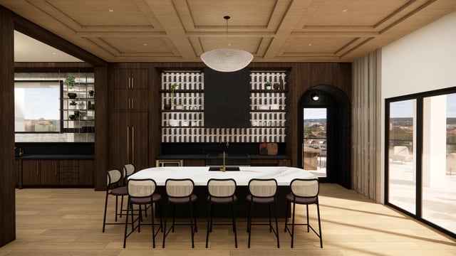 Modern kitchen with large island, bar stools, and sleek cabinetry.