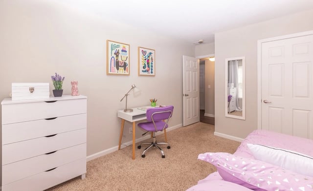 Bedroom with a desk, chair, dresser, and bed.