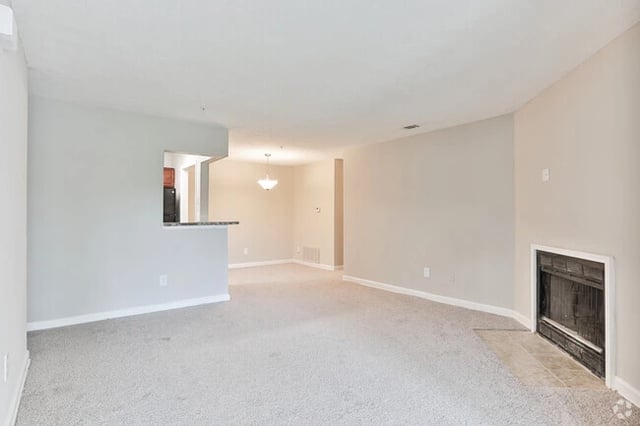 Living room with a fireplace and a pass-through to the kitchen.