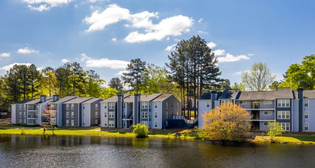 Apartment buildings next to a lake.