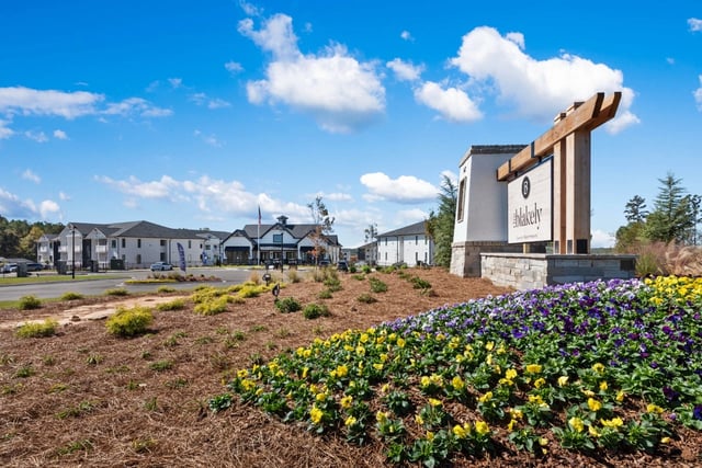 Blakely Luxury Apartments entrance sign with landscaping and buildings in background.