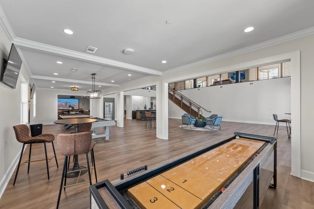 Community lounge with shuffleboard, pool table, and seating areas at The Blakely, offering apartments for rent in Pendergrass, GA.