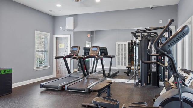 Fitness center with treadmills, elliptical, and free weights.