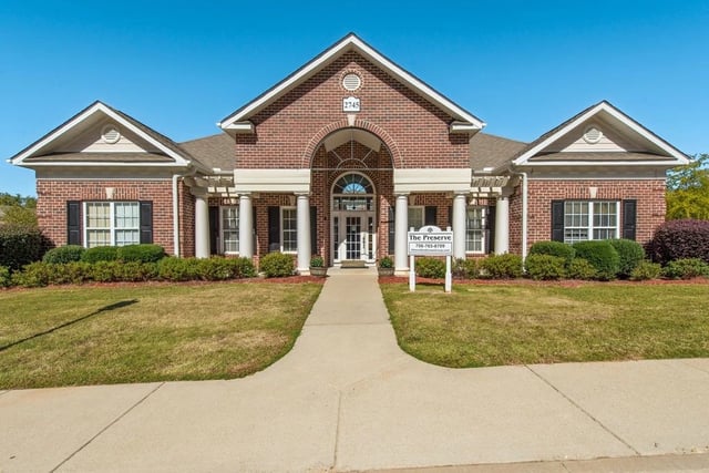 The Preserve building exterior with a clean walkway and manicured lawn.