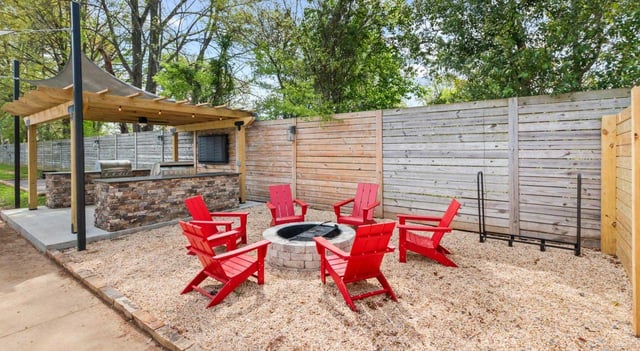 Outdoor seating area with fire pit and built-in grill station