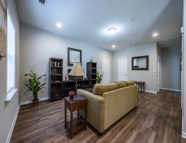 Living room with a couch, side table, and bookshelf.
