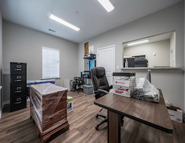 Office space with desks, chairs, and filing cabinets.