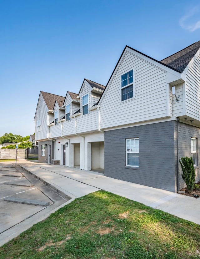 Exterior of townhomes with garages and manicured landscaping