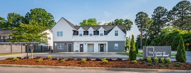 The Gates at South Bend monument sign in front of apartment buildings.