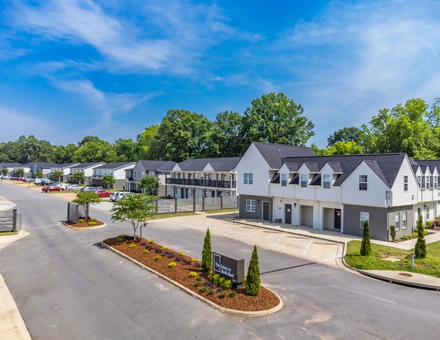 The Gates at South Bend apartment complex exterior with townhome-style buildings and manicured landscaping.