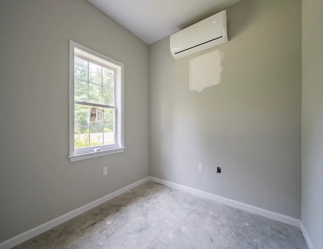 Interior view of a bedroom with a window and air conditioning unit.